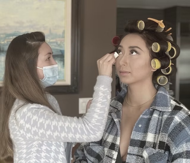 Pamela applying makeup to a bride in preparation